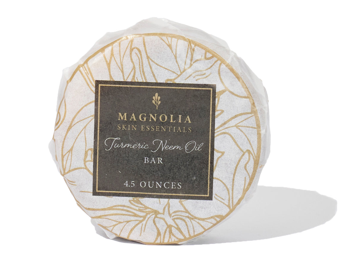 Turmeric and Neem Oil Bar in gold-and-white floral packaging