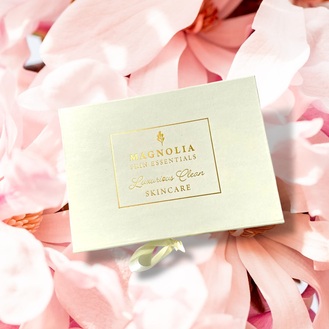 Magnolia Skin Essentials gift box on pink flower petals