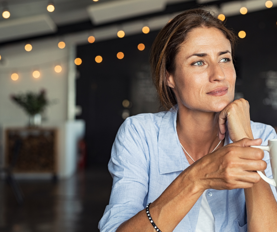 Thoughtful woman resting her chin on her hand in a café