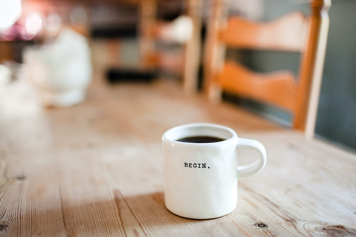White coffee mug on a wooden café table