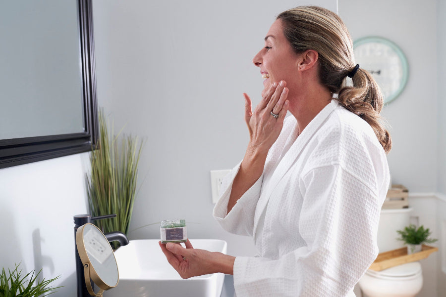 Woman massaging Magnolia Jojoba Brightening Face Scrub onto her face