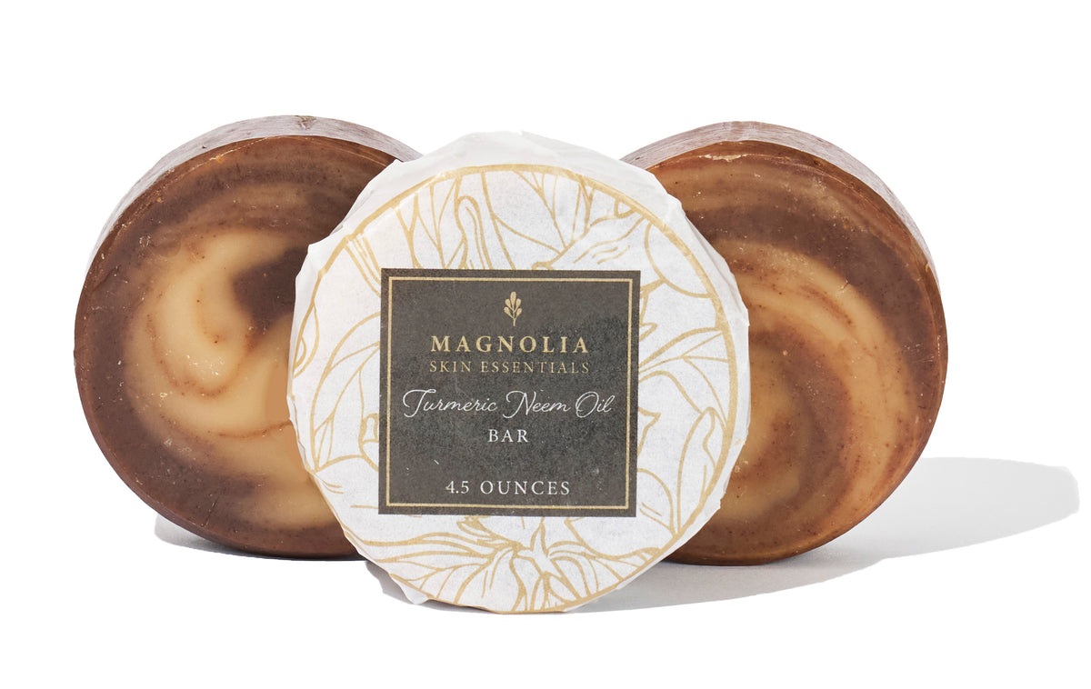 Turmeric and Neem Oil Bars beside their Magnolia Skin Essentials label