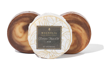 Turmeric and Neem Oil Bars beside their Magnolia Skin Essentials label